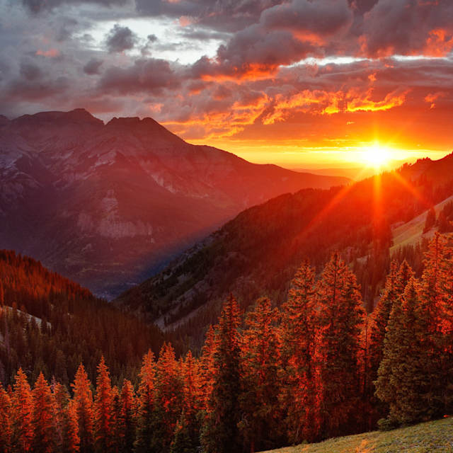 A sunset over a mountain sky