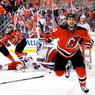New Jersey Devils Adam Henrique scores the game winning goal in overtime  against the New York Rangers in game 6 of the Eastern Conference Finals of  the Stanley Cup Playoffs at the