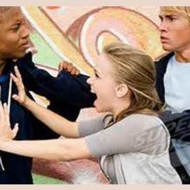 Move between the two men, and calmly try and defuse the situation
