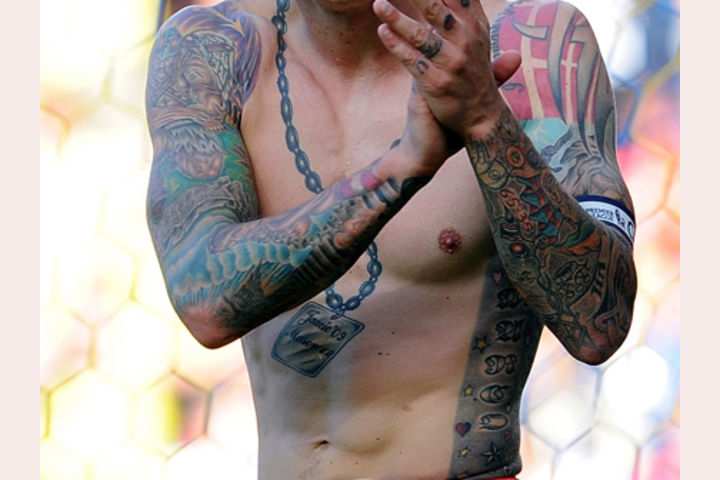 Can you identify the footballer from their tattoo?