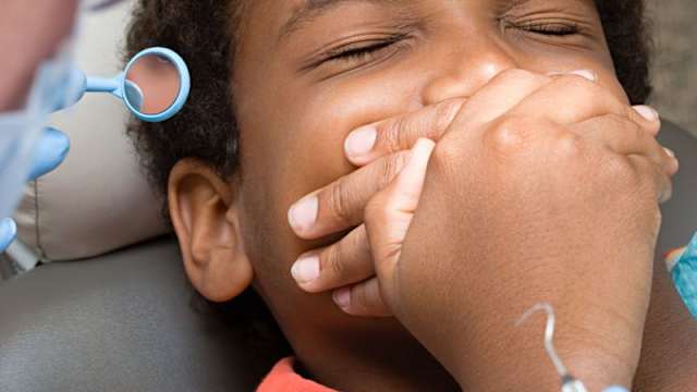 9-year-old Michael Flemming's mother signed what she believed to be a permission form for a dentist visiting his school to perform a routine cleaning on her son's teeth. When he came home with three missing, she was outraged. Do you think this should have happened?