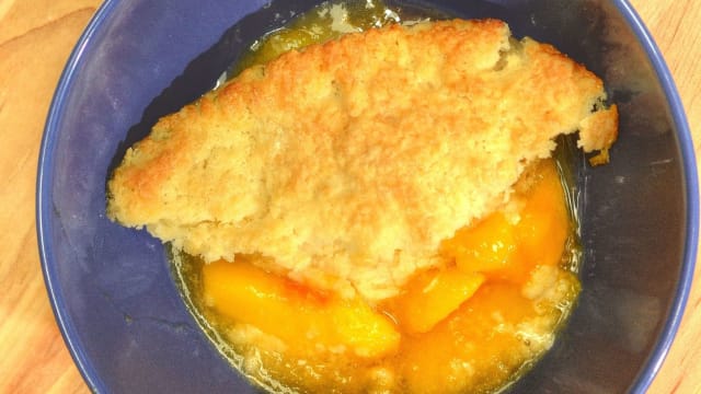 Yield: 1 8-inch square or 9-inch skillet
Adapted from the classic, “The Fannie Farmer Baking Book” by Marion Cunningham, this traditional cobbler uses rich biscuit dough to cover the fruit. This version highlights peaches, but one of the beauties of a cobbler is that any ripe, seasonal fruit can be used.