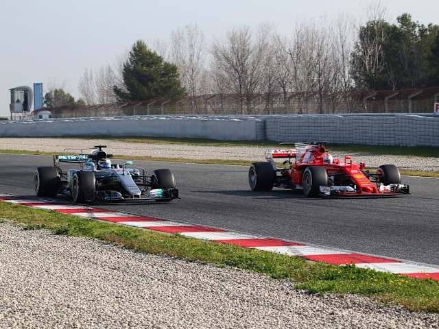 Eyeing up the competition on day one... Bottas and Vettel become close company on track