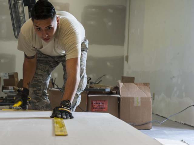 The next step in your  DIY concrete countertop  lies in the creation of the mix. Begin by mixing two quarts of water with one pack of Z-Liqui Crete. Blend that mixture for one to two minutes before adding in two more quarts of water. Now, you’re ready to add the 60-pound bag of concrete sand mix. Once it starts to get dry, add one more quart of water. Continue to mix it for about one more minute. If you still aren’t happy with the consistency, you can slowly continue to add a bit more water, but it’s definitely recommended that you don’t put any more than one more quart. If you’ve never worked with concrete before, aim to try to get a consistency similar to that of thick pancake batter. Prior to pouring in the mix, mist your form a bit. Once you pour all of it out, make sure you really get it into the edges. Using a tool such as a simple trowel is perfect for that. Afterward, take a countertop screed and level the mix with a back and forth motion. Then, start pouring in the next section. A margin trowel is great for getting everything out of your bucket. Make sure that you’re getting your mixture up to the top of the forms. A bit later in the process, you want to make sure that you’re putting in some vibrations into the forms to get out all of the air pockets. So, take the handle of the margin trowel and tap it on the outside. Make sure that you’re giving it a good tap across the entire space. Afterward, you want to continue to smooth it out with your screed. Move it across at a 45-degree angle from one corner and then the other, finishing in a straight down motion. It’s smart to tape some rosin paper to the floor and cover your cabinets in order to protect them against any sort of spillage. Once, you’re all done, take a magnesium float to flatten it all out by moving it back and forth. Don’t hesitate to go back in with some more concrete if there are some spots or dents. Now, you just need to wait a bit for it to harden.If you touch your concrete and it leaves very light marks, you’re ready for the next step. Make half moon strokes with your tool and at about a quarter inch above the surface. Don’t drag it so that it doesn’t chip your surface. Then, let it dry some more.When you come back and hear a soft scraping noise come from your trowel, your countertop is ready for the final finish. Keep using the steel trowel to smooth it out, but have a wet towel handy in order to continuously wipe off any of the dry concrete that gets on it. This will give you the ultimate flat surface.In order to remove the forms, use a gem pad to carefully sand off the excess concrete that’s on top of the edge of the form to prevent it from chipping backward. With a putty knife, separate the form from the concrete, loosen it up, and then pull it off with your hands. You may notice a few air bubbles, but there’s no need to worry as you can just fill those in with Z-counter patch and then sand them a bit. 
