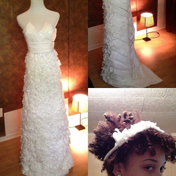This sharp sweetheart neckline gown features a chevron pleated bodice and back and a matching headband, but the real star of this gown is the front of the skirt, which features tons of textured floral detail.