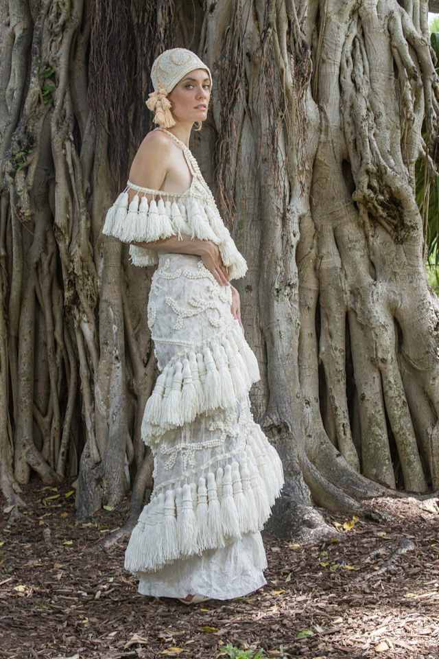 Carol Touchstone created this one-of-a-kind 1920s-inspired gown with a matching hat. This tassel-covered drop-waist gown also features a stunning neckline with unique cutouts that make it a perfect match for the modern bride.