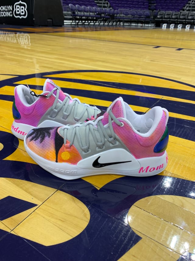 Set along a beach background paying tribute to her native Australian island of Torres, Leilani Mitchell’s custom low-top Hyperdunks honor the women in her family who have inspired her over the years: Nana, Grandma and Mom. The island’s flag can be found along the heel, and a fading sunset makes up the main artwork of the shoe.