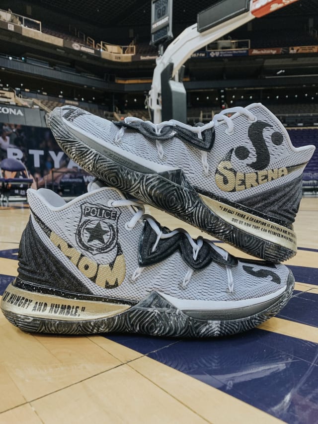 Although some players opted for louder and more vibrant colors, Brianna Turner chose a simpler black-and-white approach, with championship gold accents, to honor two women she has long admired. “Mom” and “Serena” can be spotted inside each Swoosh logo, with a police badge on the right collar celebrating Turner's mother’s career in the justice system. Turner's mother’s nickname for her, “SLIM,” is prominently placed atop the right toe. The tennis icon’s logo is incorporated just above the left Swoosh, and a portrait of her is painted along the toe.Quotes from each can be seen along the gold-painted heel. “Stay hungry and humble,” a guiding line from Turner's mom, sits opposite her favorite Serena Williams quote: “I really think a champion is defined not by their wins but by how they can recover when they fall.”